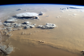 Dust and Clouds Dance Over the Sahara